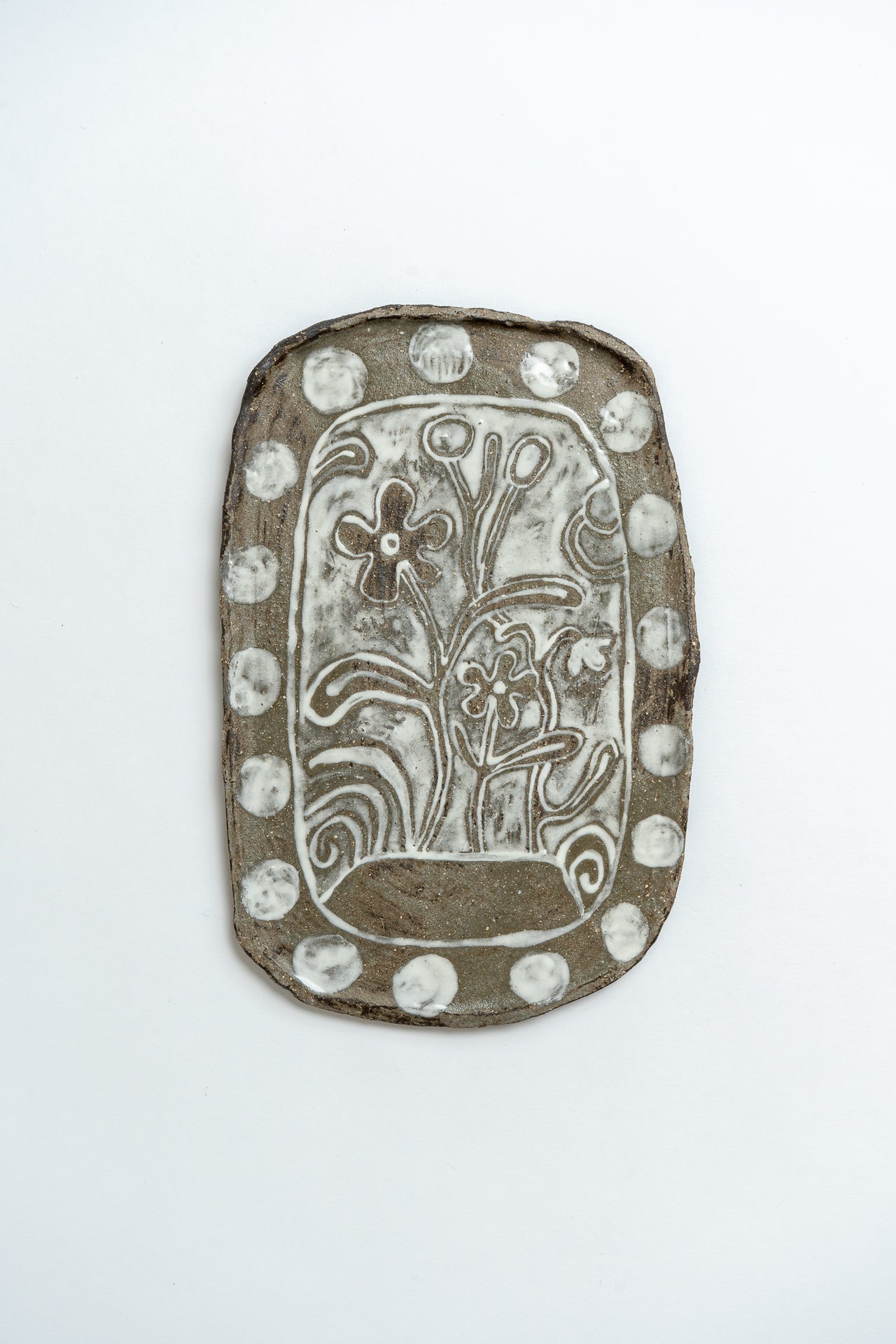 Decorative plate with floral design on a white background by ceramicist Studio Alice Johnson