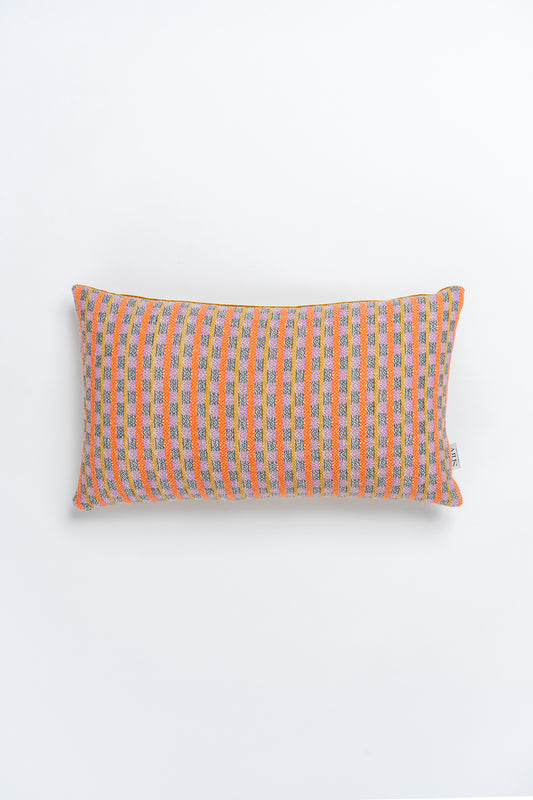A rectangular bolster cushion with a geometric pattern in orange and pink tones.