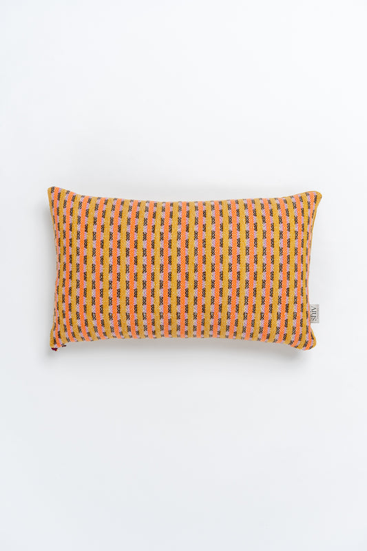 A rectangular bolster cushion with a geometric pattern in orange and white colors, woven with recycled yarn.