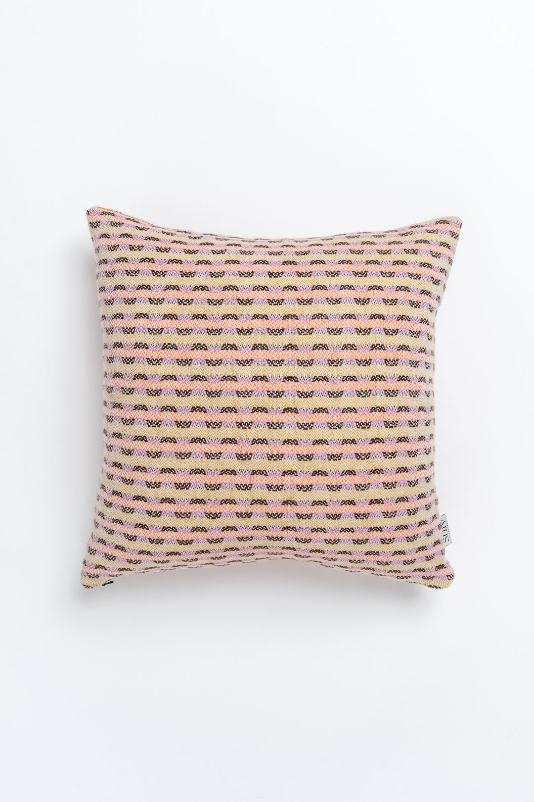 A square-shaped cushion with a geometric pattern in pink and orange tones, likely made from a blend of lambswool and cashmere.