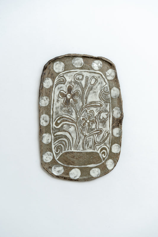 Decorative plate with floral design on a white background by ceramicist Studio Alice Johnson