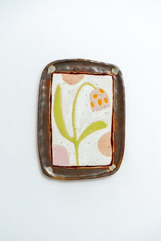 Decorative ceramic plate with floral tulip design on a white background by British contemporary ceramicist Studio Alice Johnson