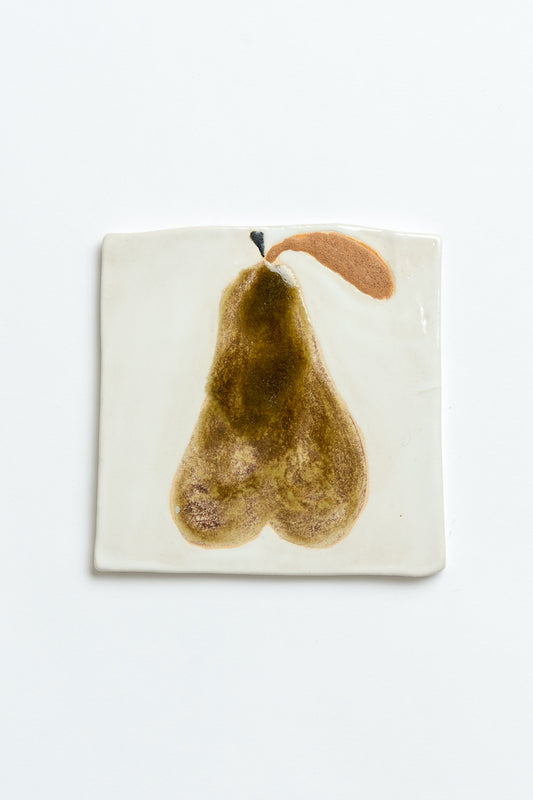 Coaster with a pear design on a white background hand made by contemporary British ceramicist Studio Alice Johnson in collaboration with MIMMO Studios