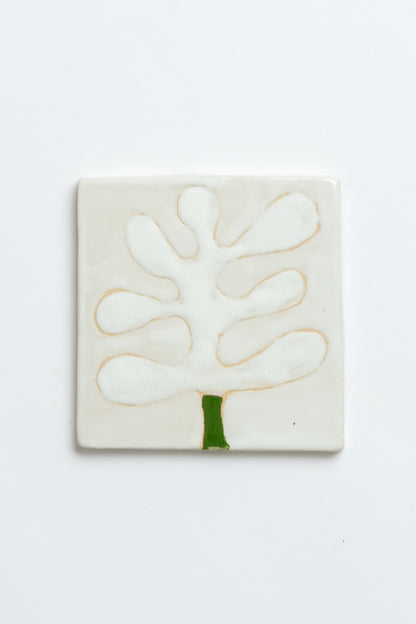 Square ceramic tile with a white abstract design on a light grey background Two square tiles with spiral patterns on a white background handmade by contemporary British ceramicist Studio Alice Johnson