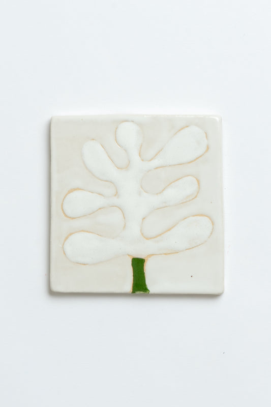 Square ceramic tile with a white abstract design on a light grey background Two square tiles with spiral patterns on a white background handmade by contemporary British ceramicist Studio Alice Johnson