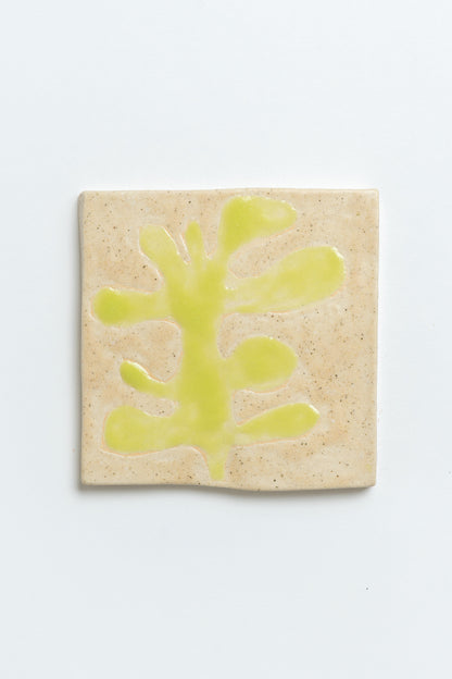 Hand painted ceramic tile with green leaf motif and beige background. MIMMO Studios x Studios Alice Johnson collaboration.
