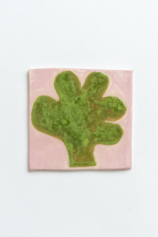 Green abstract design on a pink textured background Two square tiles with spiral patterns on a white background handmade by contemporary British ceramicist Studio Alice Johnson