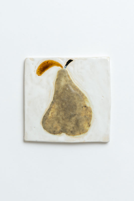 Square ceramic tile with a pear design on a white background by contemporary British ceramicist Studio Alice Johnson