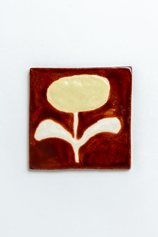Square ceramic tile with a floral design on a white background by contemporary British ceramicist Studio Alice Johnson