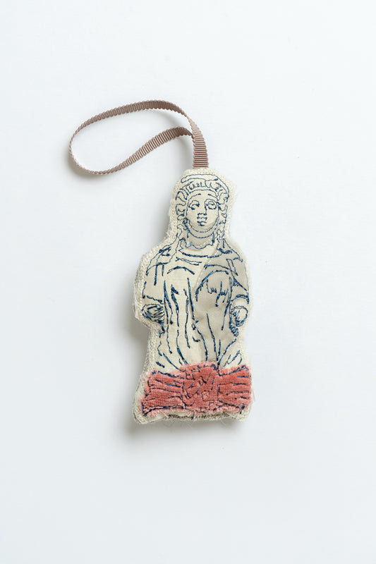 Decorative Christmas decoration shaped like a classical figure on a white background, inspired by the caryatid stone ladies in Montpellier Cheltenham. Iconic landmark. MIMMO Studios x Ludio Christmas collaboration