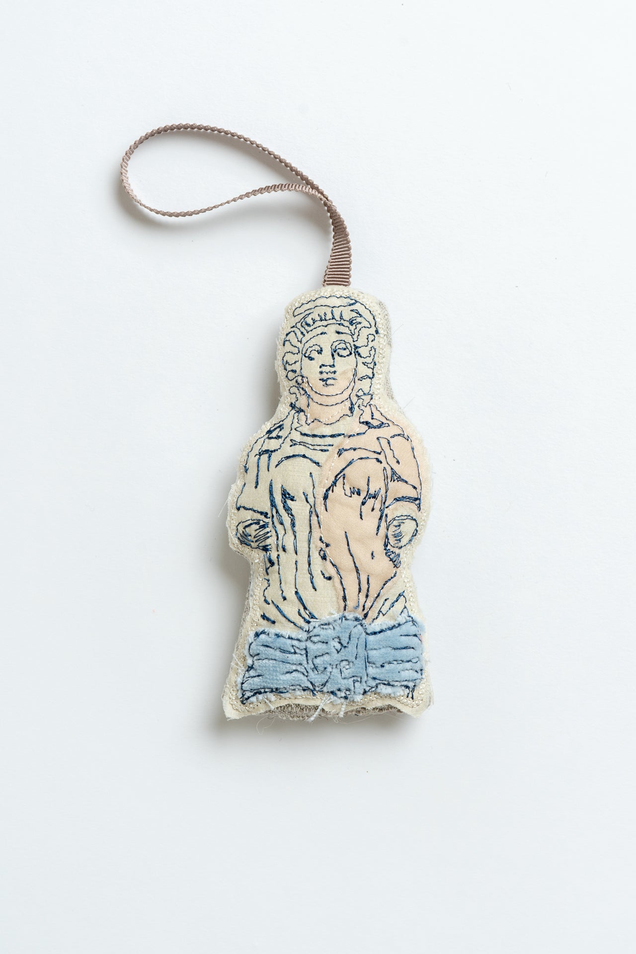 Decorative Christmas decoration shaped like a classical figure on a white background, inspired by the caryatid stone ladies in Montpellier Cheltenham. Iconic landmark. MIMMO Studios x Ludio Christmas collaboration