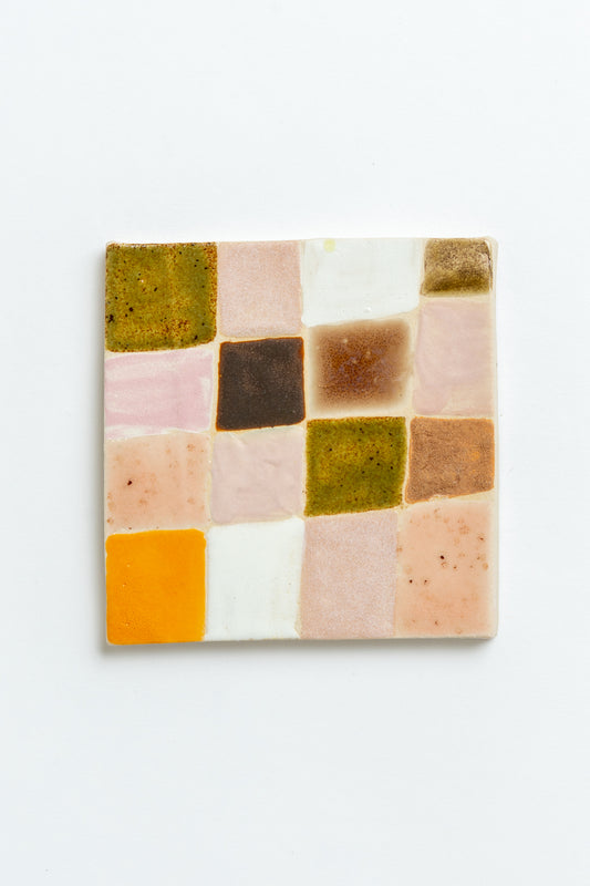 Square ceramic tile with a patchwork of multicolored squares on a white background handmade by contemporary British ceramicist Studio Alice Johnson in collaboration with MIMMO Studios