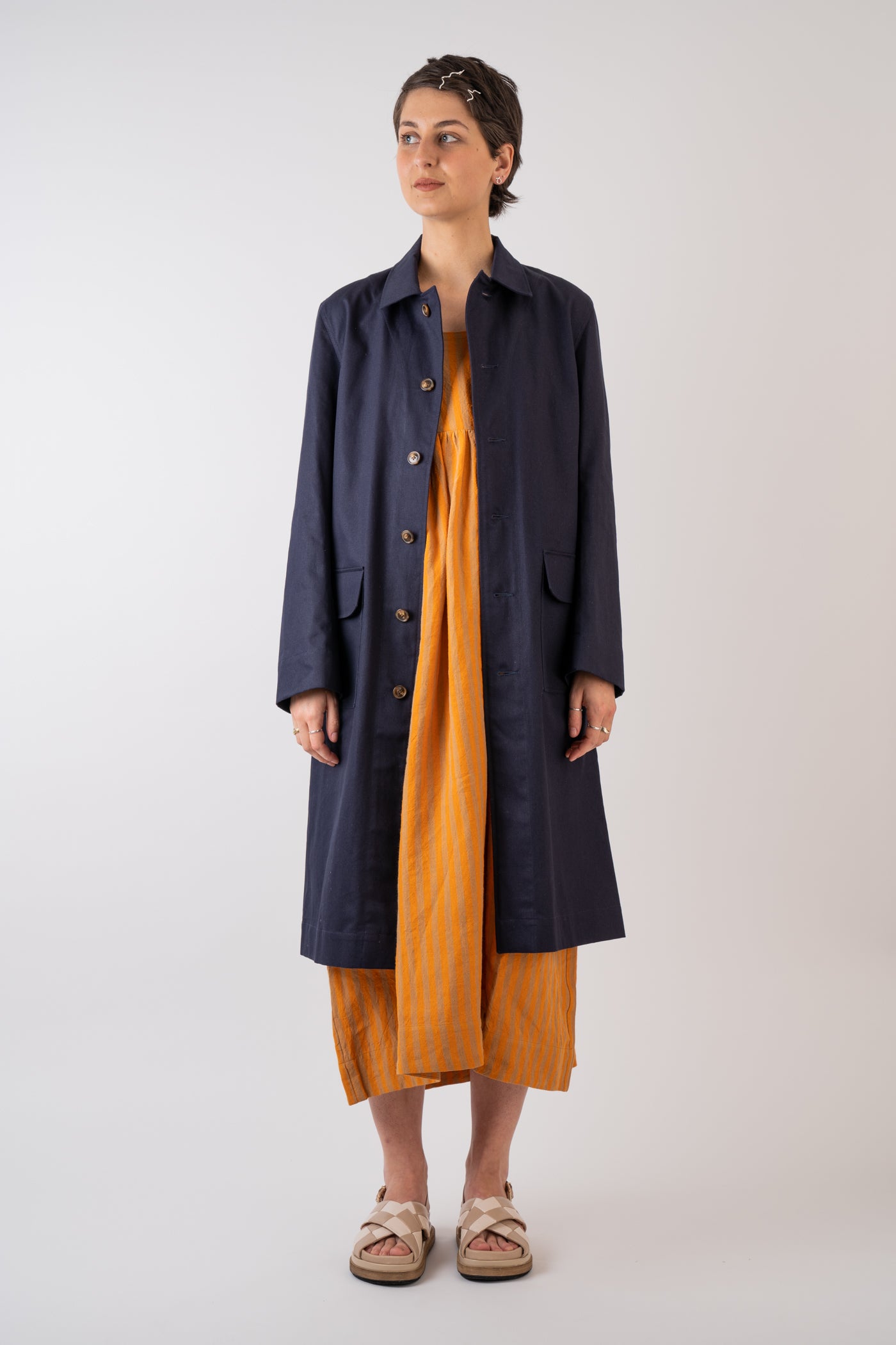 Xi Atelier Organic Cotton Drill Yves Coat in Navy handmade in Glasglow styled with Cawley Studio Elba Linen Stripe Dress